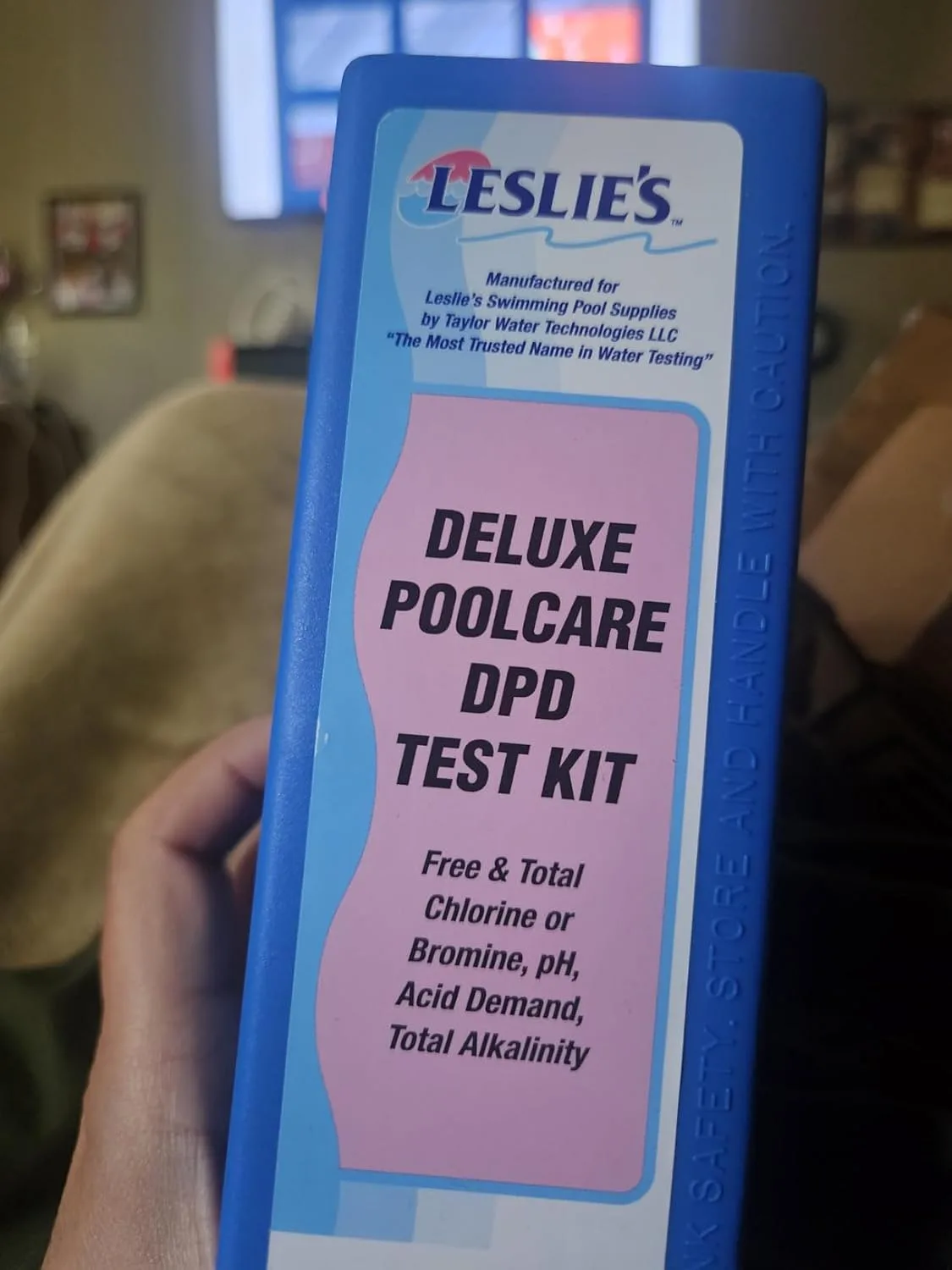 Customer photo of pool test strips being used to measure chlorine levels in pool water