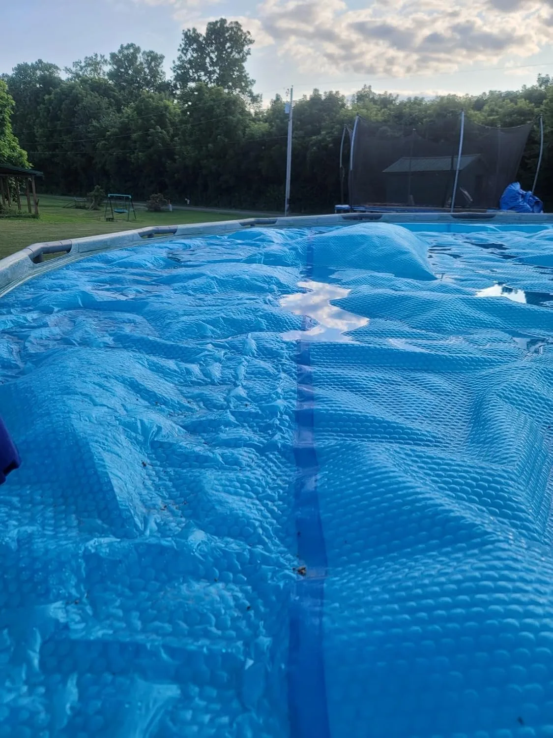 Customer photo of solar pool cover installed on swimming pool surface
