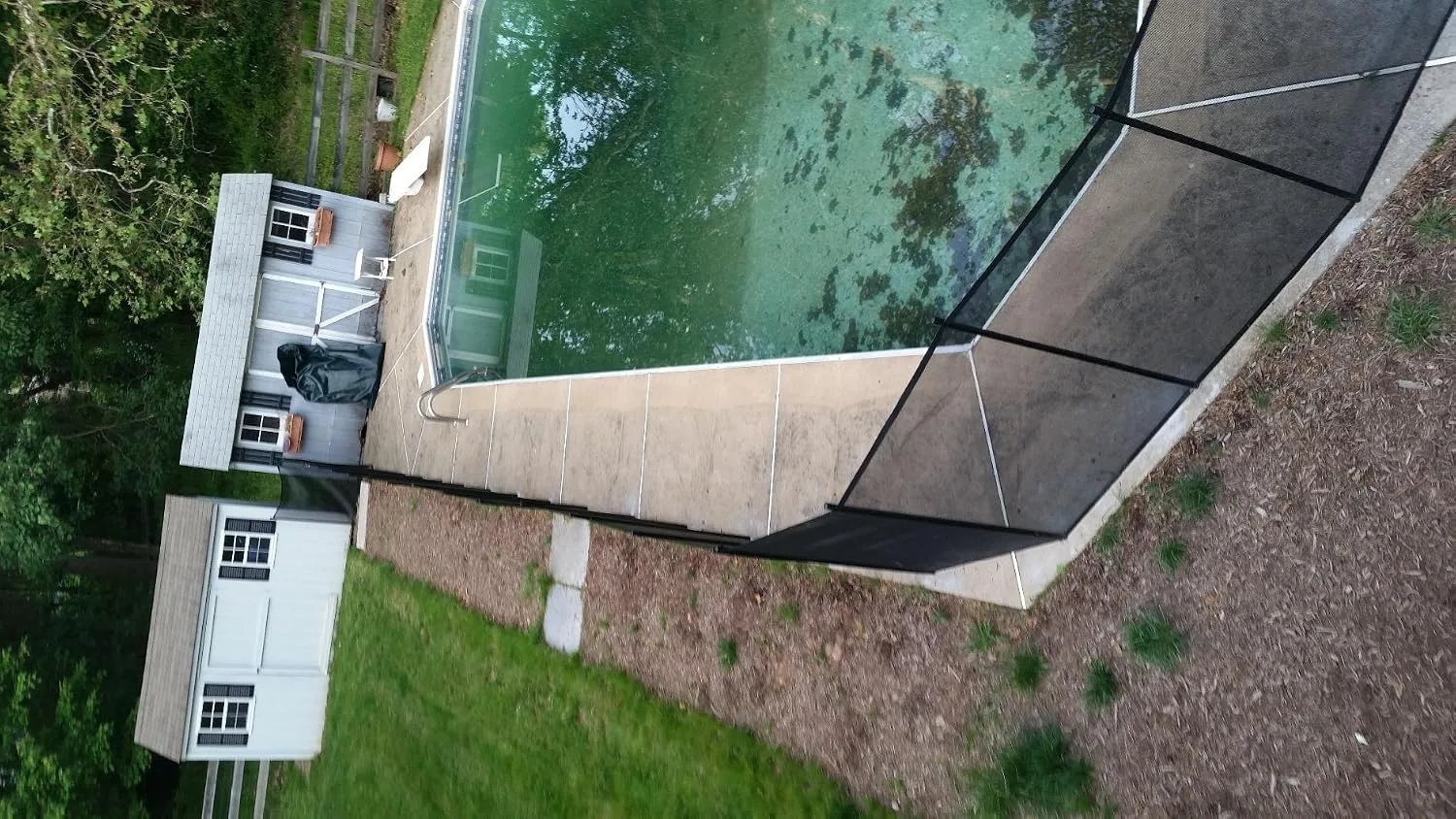 Customer photo of mesh pool fence installed around residential swimming pool