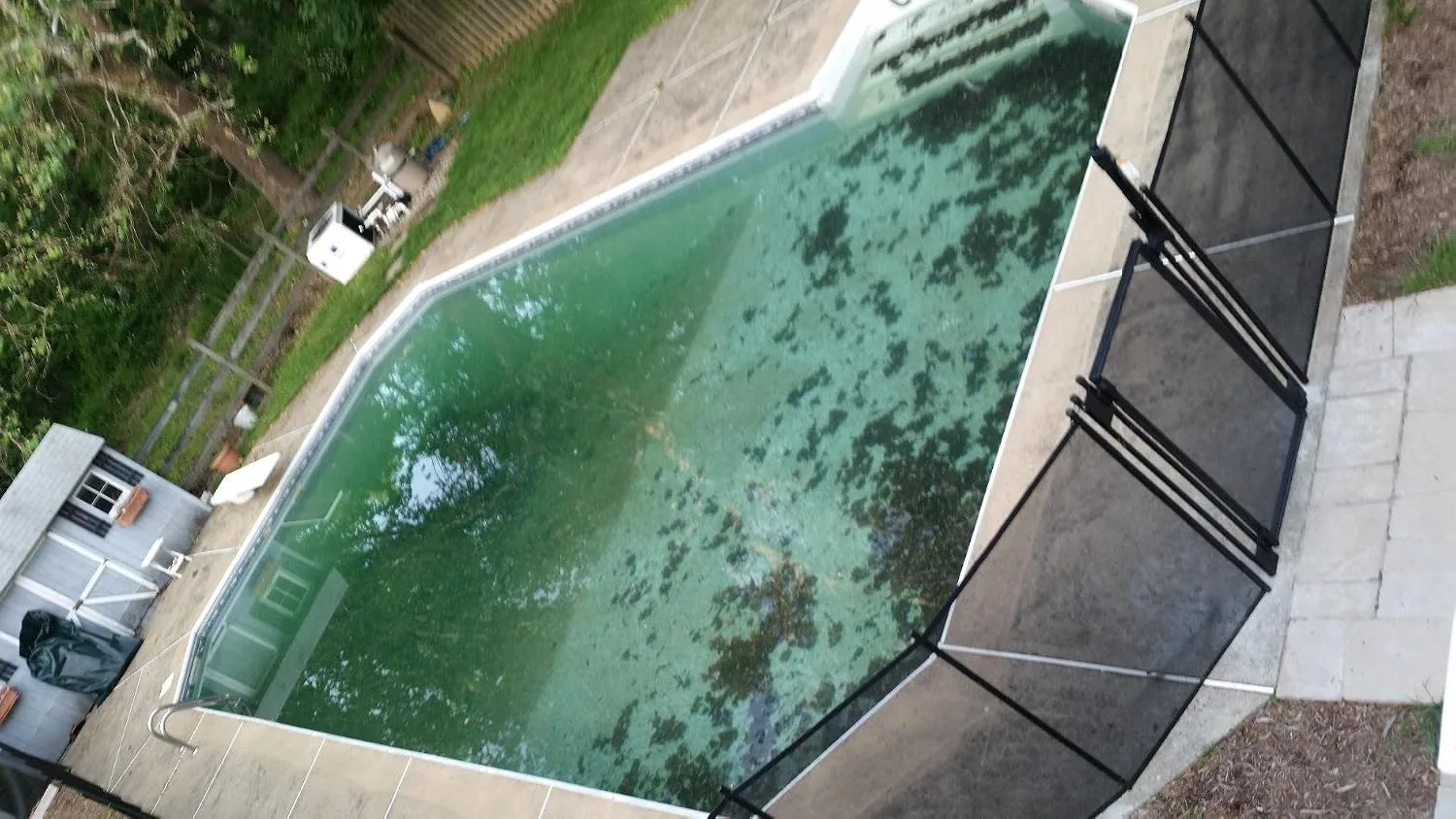 Customer photo of mesh pool fence installed around residential swimming pool