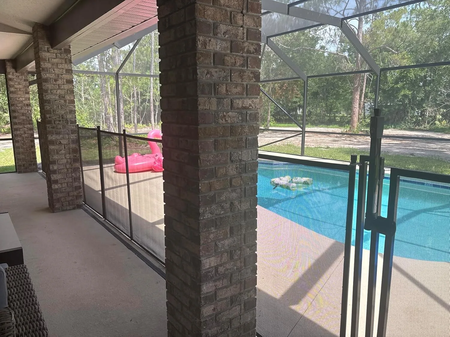 Customer photo of mesh pool fence installation showing safety barrier around residential pool perimeter