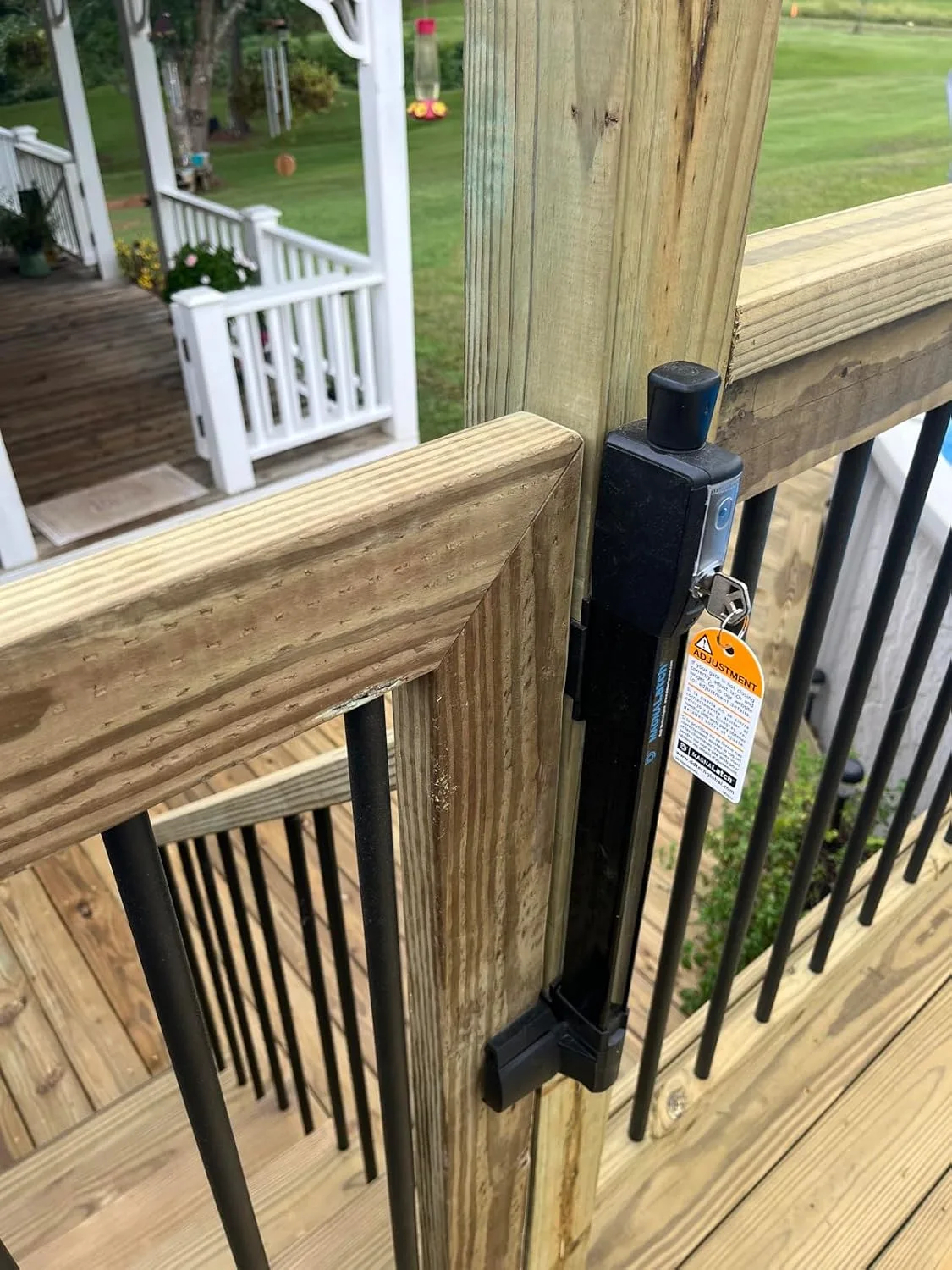 Customer photo showing pool gate installation on residential pool fence with toddler safety latch engaged