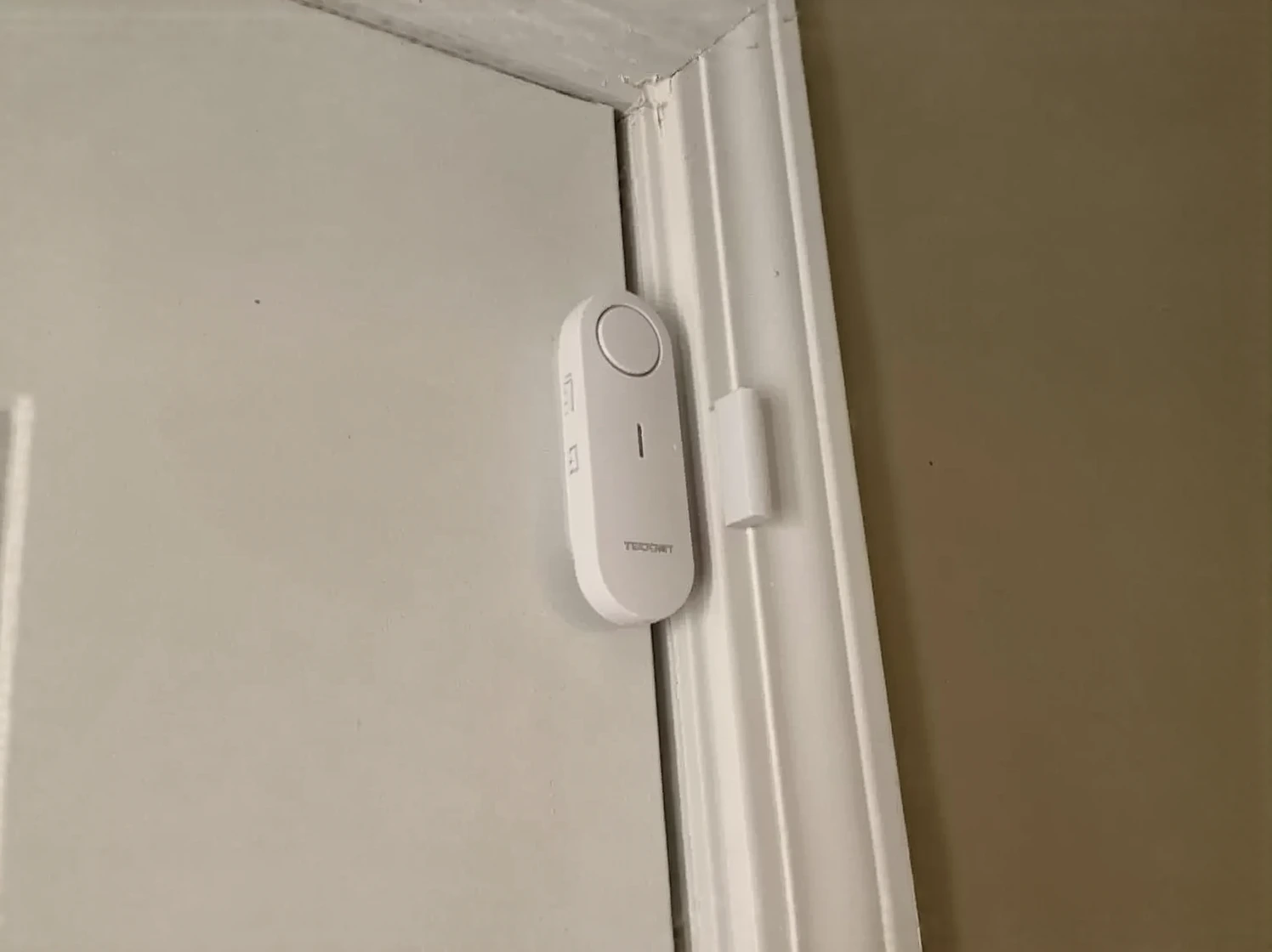 Customer photo of pool alarm sensor mounted on pool edge with cover partially visible