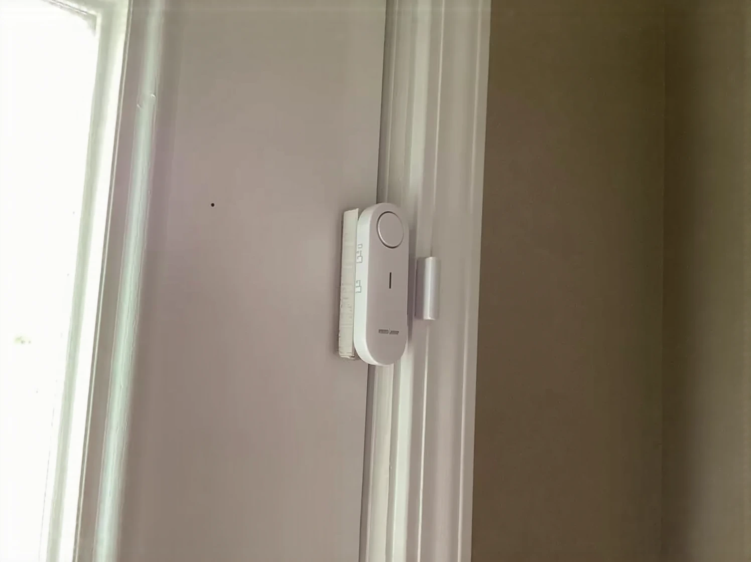 Customer photo of pool alarm sensor installed on pool edge with cover partially visible
