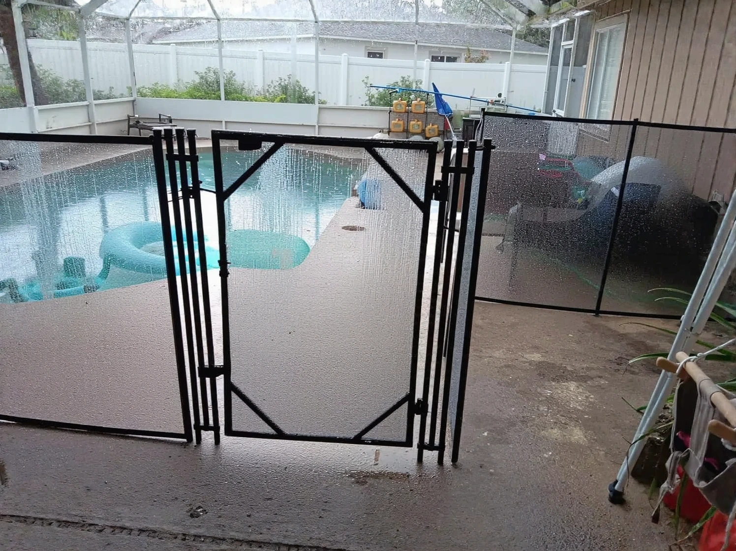 Customer photo of removable pool fencing installed around residential swimming pool