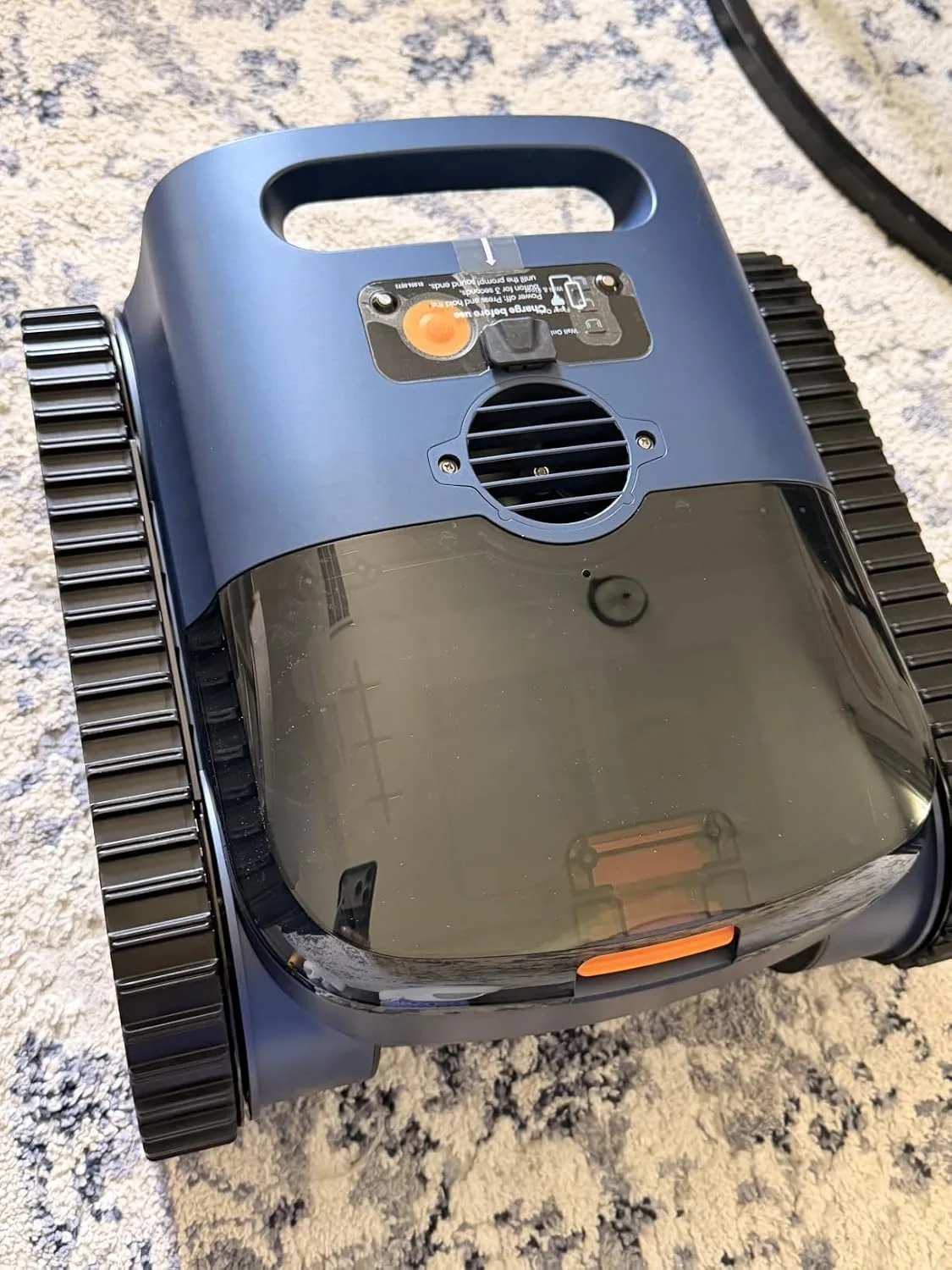Customer photo of robotic pool cleaner device sitting on pool floor ready to clean